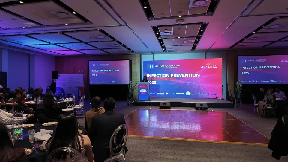 Delegates around the branded stage at the 2025 Melomed conference.